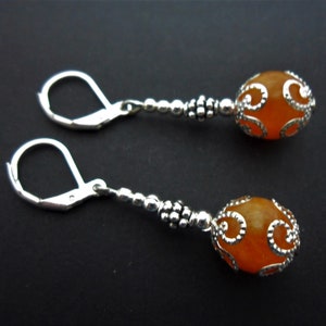 A pair of hand made dangly orange jade bead leverback hook earrings. New.