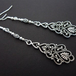 A pair of pretty tibetan silver filigree long dangly earrings.