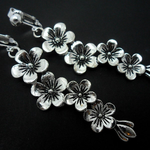 A pair of pretty tibetan silver flower  themed  dangly clip on earrings.