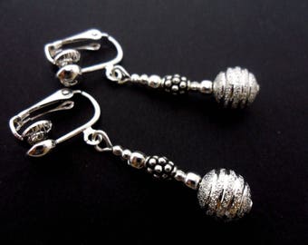 A pair of hand made tibetan silver dangly clip on earrings.