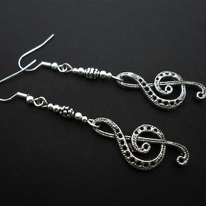 A pair of cute tibetan silver black crystal bead treble clef musical note  themed  dangly earrings.