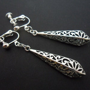 A pair of pretty tibetan silver teardrop filigree dangly clip on earrings.
