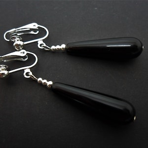 A pair of pretty black onyx bead long dangly teardrop clip on earrings.