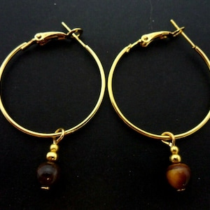 A pair of gold colour 30mm 1&quot; hoop and tigers eye bead earrings.