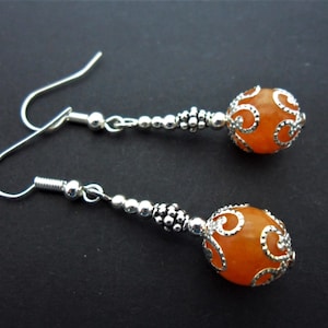 A pair of hand made dangly orange jade bead  earrings. New.