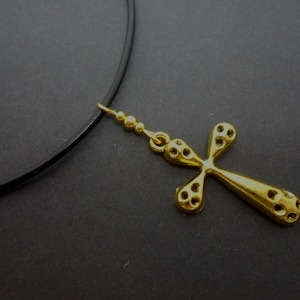 A leather cord 13&quot; - 14&quot; gold colour cross charm choker necklace.