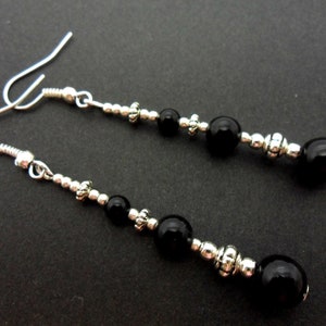 A pair of pretty tibetan silver & black onyx bead long dangly earrings.