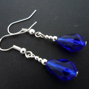 A pair of pretty silver plated cobalt blue glass crystal  teardrop bead dangly earrings.