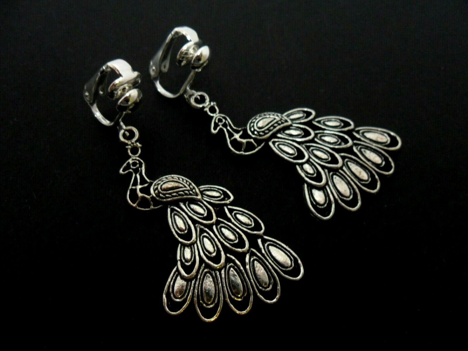 A pair of tibetan silver peacock bird themed dangly clip on earrings. new.