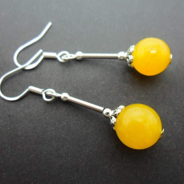 A pair of hand made silver plated yellow jade bead dangly earrings with 925 solid silver hooks.