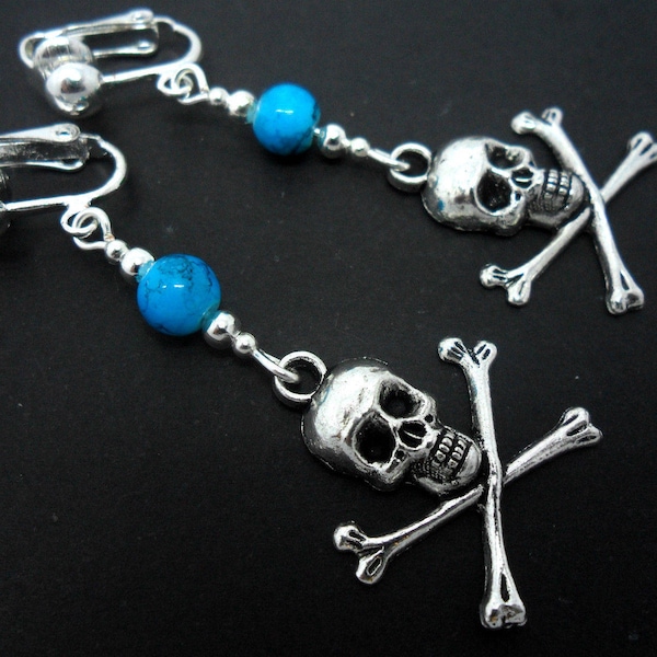 A pair of tibetan silver skull crossbones & turquoise bead dangly clip on earrings.