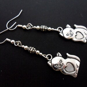 A pair of pretty hand made tibetan silver cat themed  dangly earrings. new.
