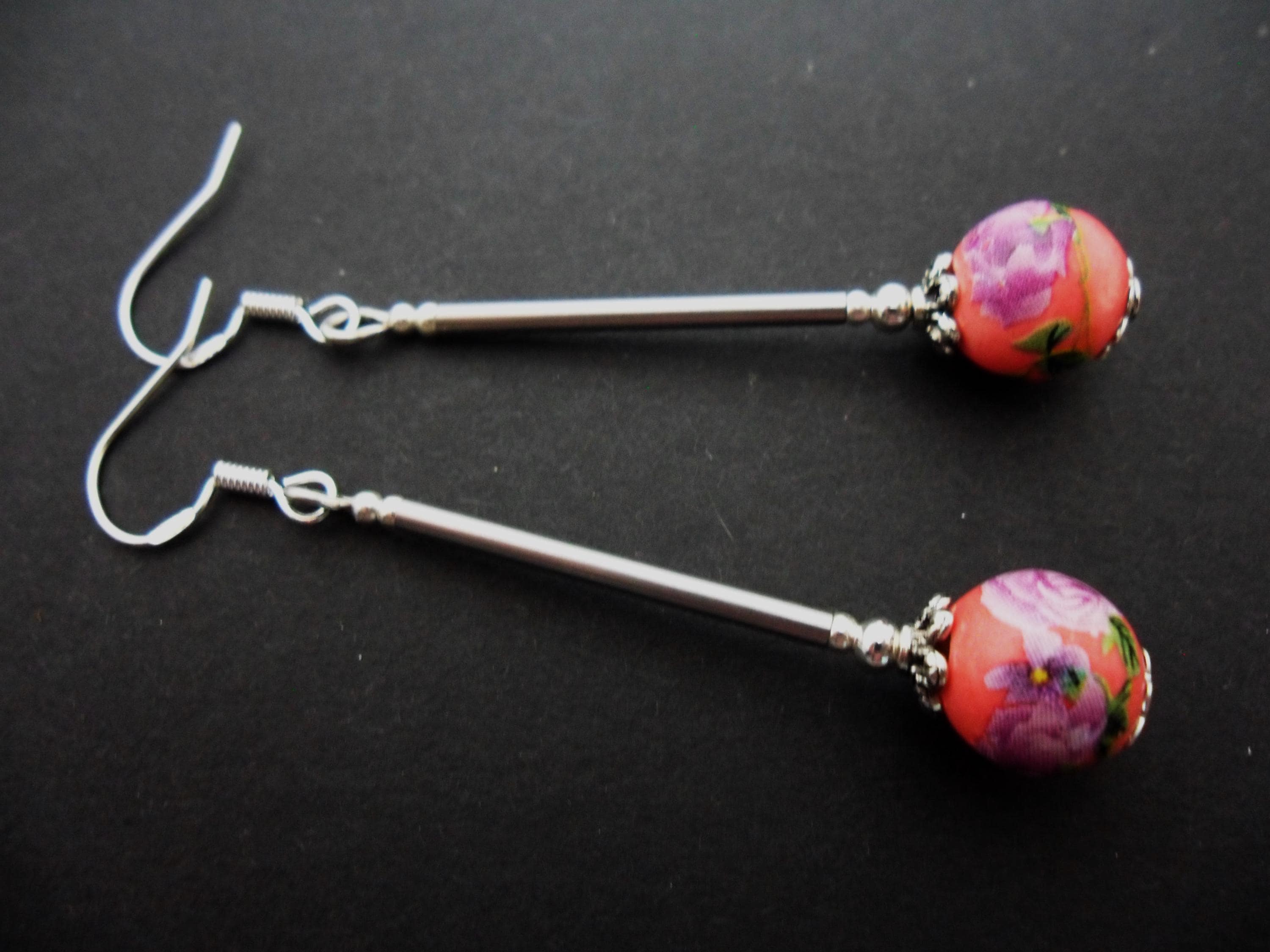 A pair of hand made cute long dangly pink/purple flower porcelain earrings with 925 solid silver hooks.