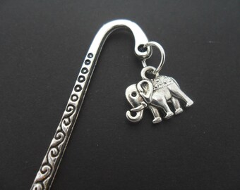 May include: Silver bookmark with an ornate design and a silver elephant charm.