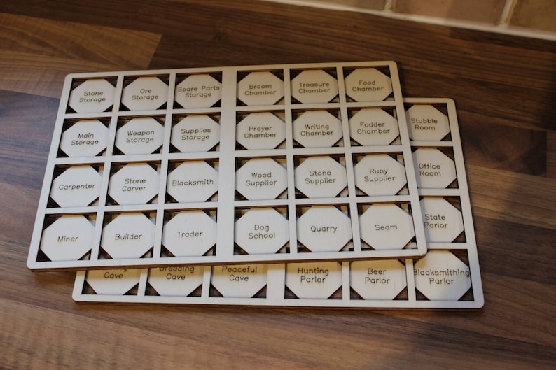May include: A wooden board with 49 hexagonal spaces, each with a different label. The labels include "Stone Storage", "Ore Storage", "Spare Parts Storage", "Broem Chamber", "Treasure Chamber", "Food Chamber", "Main Storage", "Weapon Storage", "Supplies Storage", "Prayer Chamber", "Writing Chamber", "Fodder Chamber", "Stutible Room", "Carpenter", "Stone Carver", "Blacksmith", "Wood Supplier", "Stone Supplier", "Ruby Supplier", "Office Room", "Miner", "Builder", "Trader", "Dog School", "Quarry", "Seam", "State Parior", "Cave", "Breeding Cave", "Peaceful Cave", "Hunting Parlor", "Beer Parlor", and "Blacksmithing Parlor".