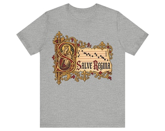 May include: A heather grey t-shirt featuring a large, ornate letter S in red and gold. Inside the letter is an illustration of a crowned figure holding a child. Next to it is a musical staff with notes and the text Salve Regina in black.