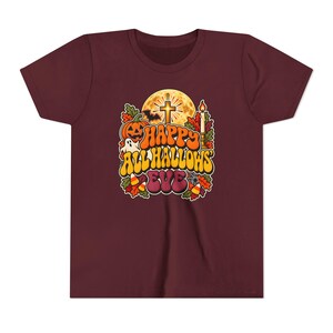 Kinder T-shirt met katholieke Halloween-opdruk, retro en groovy Halloween-shirt, pompoen met kruis en maan. afbeelding 7