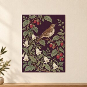 May include: A rectangular wall art print featuring a brown speckled bird perched on a branch amidst green leaves, white bell-shaped flowers, and clusters of red raspberries set against a deep dark purple background.