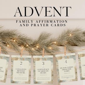 May include: Advent family affirmation and prayer cards. The cards are numbered 1 through 5 and are hanging from a string with small wooden clothespins. The cards have text that includes Bible verses and affirmations.