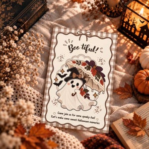 May include: A rectangular Halloween greeting card with a beige and white gingham border. The card features a white ghost wearing a black witch hat, holding a patterned umbrella with autumn leaves. Text reads: Boo tiful! Come join us for some spooky fun! Let's make some sweet Halloween memories.