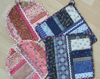 May include: Four quilted pot holders in various colors and patterns. Two are round and two are square. The round pot holders have a pink and brown color scheme with floral patterns. The square pot holders have a blue and white color scheme with floral and geometric patterns.
