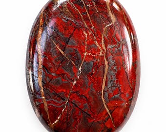 May include: An oval-shaped polished gemstone featuring a deep red base color with intricate dark gray and black swirling patterns, accented by thin, light-colored mineral veins running across the smooth, glossy surface.