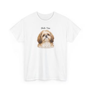 May include: A white short-sleeved t-shirt featuring a centered illustration of a brown and white Shih Tzu dog. Above the dog's head, the text Shih Tzu is printed in a simple black font. The garment has a crew neckline and short sleeves.