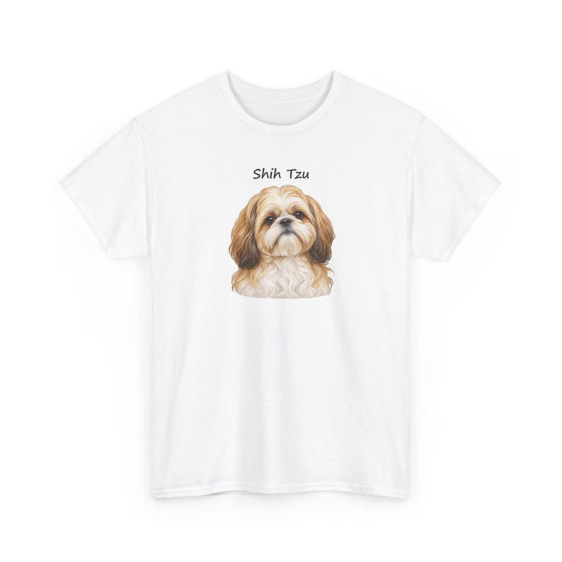 May include: A white short-sleeved t-shirt featuring a centered illustration of a brown and white Shih Tzu dog. Above the dog's head, the text Shih Tzu is printed in a simple black font. The garment has a crew neckline and short sleeves.