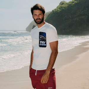 May include: A white short-sleeved t-shirt featuring a graphic of a smartphone displaying a credit card and the text PAY ATTENTION, paired with maroon shorts that have a white drawstring and a small white logo on the lower left leg.