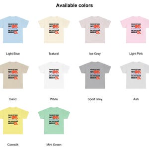May include: A collection of ten short-sleeve t-shirts in light blue, natural, ice grey, light pink, sand, white, sport grey, ash, cornsilk, and mint green. Each shirt features the text: FROM 100 FEET AWAY, YOU'RE 100%... SAME, EVERY FOOT CLOSER KNOCKS OFF 1%.