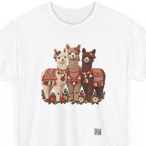 Alpaca t-shirt, Three alpacas in Andean blankets and flower crowns, front print of the t-shirt. A white t-shirt featuring a graphic print of three llamas standing together.