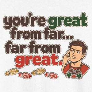 May include: A white graphic t-shirt featuring the text you're great from far... far from great. in brown, green, and red. An illustration of a person with brown hair, a red shirt, and binoculars around their neck is included.