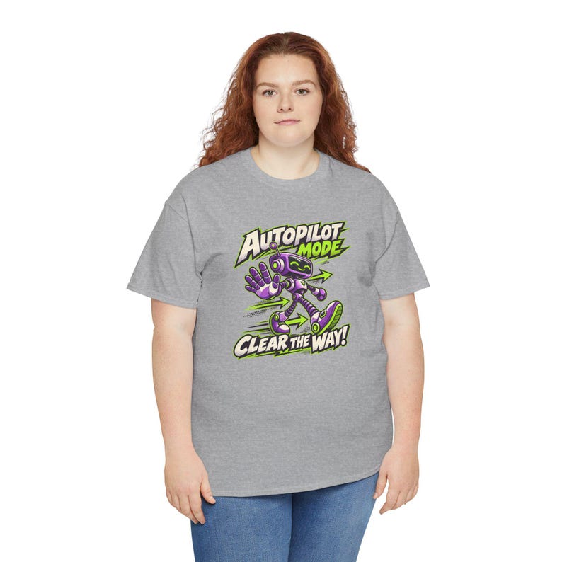 May include: A heather gray short-sleeve t-shirt featuring a graphic of a purple robot walking with one hand raised. The text reads AUTOPILOT MODE and CLEAR THE WAY in bold white and green lettering with green directional arrows.