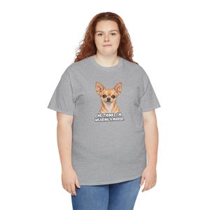 May include: A heather gray short-sleeve t-shirt featuring a graphic of a tan chihuahua dog. Below the dog, the text reads: HE THINKS I'M WEARING A MIRROR. The shirt has a crew neckline and a standard fit, providing a casual look for daily wear.
