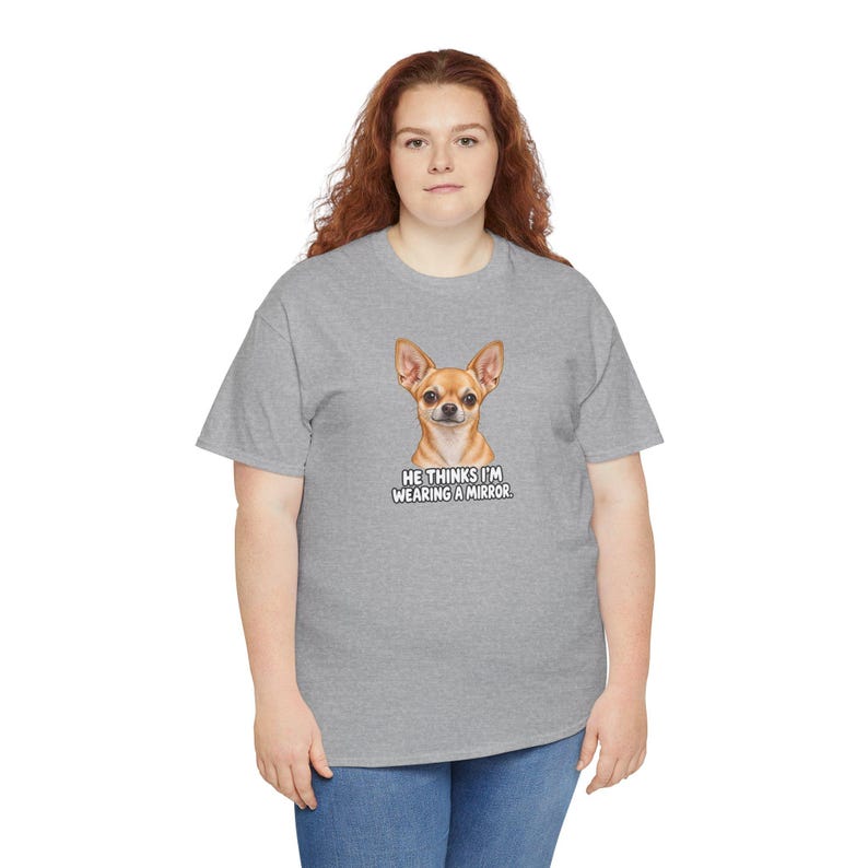 May include: A heather gray short-sleeve t-shirt featuring a graphic of a tan chihuahua dog. Below the dog, the text reads: HE THINKS I'M WEARING A MIRROR. The shirt has a crew neckline and a standard fit, providing a casual look for daily wear.