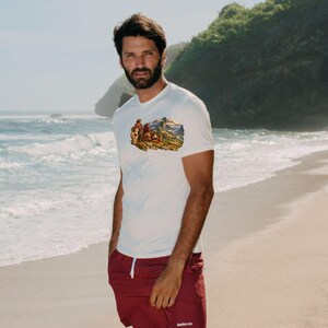 May include: A white short-sleeve t-shirt featuring a colorful graphic of llamas in a mountain landscape on the chest, paired with maroon shorts that have a white drawstring and the text bamboo ave. printed in white on the lower left leg.