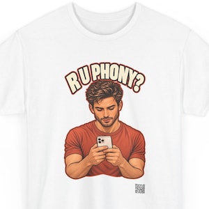 May include: A white t-shirt featuring a graphic illustration of a person with brown hair wearing a red t-shirt and looking down at a smartphone. Above the figure, the text reads RU PHONY? in a bold, arched font. A small QR code is at the bottom.
