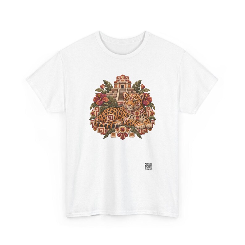 May include: A white short-sleeved t-shirt featuring a central graphic of a spotted jaguar resting in front of a stepped pyramid. The design includes red hibiscus flowers, green leaves, and geometric patterns in shades of brown, orange, and red.
