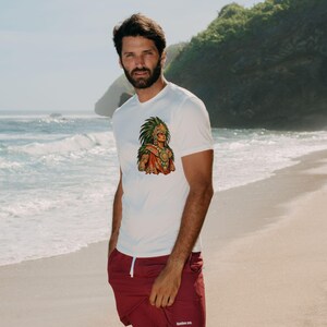 May include: A white short-sleeved t-shirt featuring a colorful graphic of an Aztec warrior in a feathered headdress on the chest, paired with solid maroon shorts that have a white drawstring and the text bamboo ave. printed on the leg.
