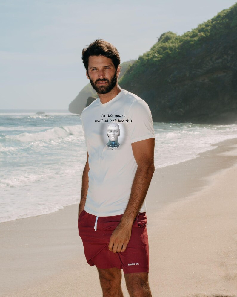 May include: A white short-sleeved t-shirt featuring a graphic of a silver robotic head and the text "In 10 years we'll all look like this" printed on the chest, paired with maroon shorts that have a small white logo on the lower leg.