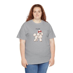 May include: A heather gray short-sleeve t-shirt featuring a graphic of a white poodle with a red bow on its head. The word Poodle is printed in black text above the dog illustration. The shirt has a crew neckline and a standard fit.