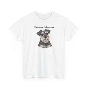 May include: A white short-sleeved t-shirt featuring a centered illustration of a black and gray Miniature Schnauzer dog. Above the dog, the text Miniature Schnauzer is printed in a simple black font. The shirt has a crew neckline.