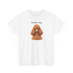 May include: A white short-sleeved t-shirt featuring a centered graphic of a brown curly-haired poodle. Above the dog illustration, the text Poodle's Day is printed in a simple black font. The shirt has a crew neckline and a standard fit.