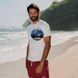 May include: A white short-sleeved t-shirt featuring a circular graphic of the Earth above a lunar surface with the text SAVE ME, paired with maroon shorts that have a white drawstring and small white text on the lower left leg.