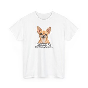 May include: A white short-sleeved t-shirt featuring a graphic of a tan Chihuahua dog centered on the chest. Below the dog, the text reads HE THINKS I'M WEARING A MIRROR in bold, black, uppercase letters with a white outline.