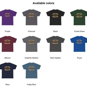 May include: A collection of ten short-sleeve t-shirts in various colours including purple, charcoal, black, forest green, maroon, graphite heather, dark heather, royal, navy, and indigo blue, each featuring a graphic of candles and the text Japanese Candles Beware of Fire.