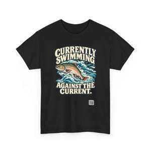May include: A black t-shirt featuring a graphic of a trout jumping through blue waves. Above the fish, the text reads CURRENTLY SWIMMING, and below the fish, the text reads AGAINST THE CURRENT. A small square QR code is printed near the bottom right.