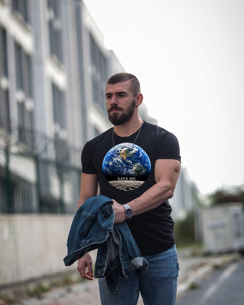 May include: A black short-sleeved t-shirt featuring a circular graphic of the Earth viewed from space above a lunar surface, with the text "SAVE ME" printed in white capital letters across the center of the design.