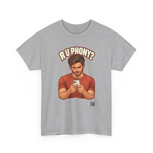 May include: A heather gray short-sleeve t-shirt featuring a graphic of a person in a red shirt looking down at a white smartphone. Above the figure, the text reads R U PHONY? in bold, cream-colored letters with a dark outline.