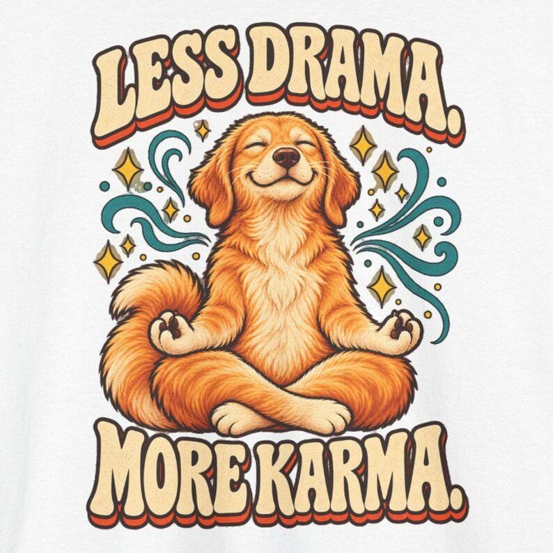 May include: A white graphic print featuring a golden-colored dog sitting in a lotus meditation pose with eyes closed. The text "LESS DRAMA." appears above the dog and "MORE KARMA." below, surrounded by teal swirling lines and yellow star shapes.